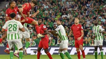 Kike Salas leaps highest to head home Sevilla's goal in the derby draw with Real Betis. (EPA PHOTO)